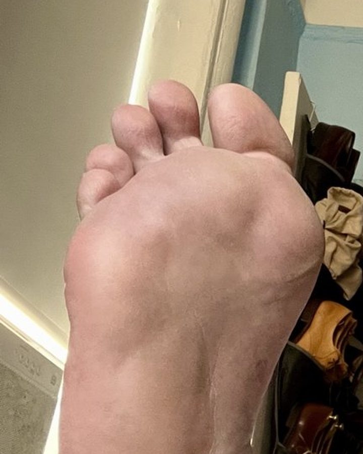 One bare size 15 sole, toes up, in studio light